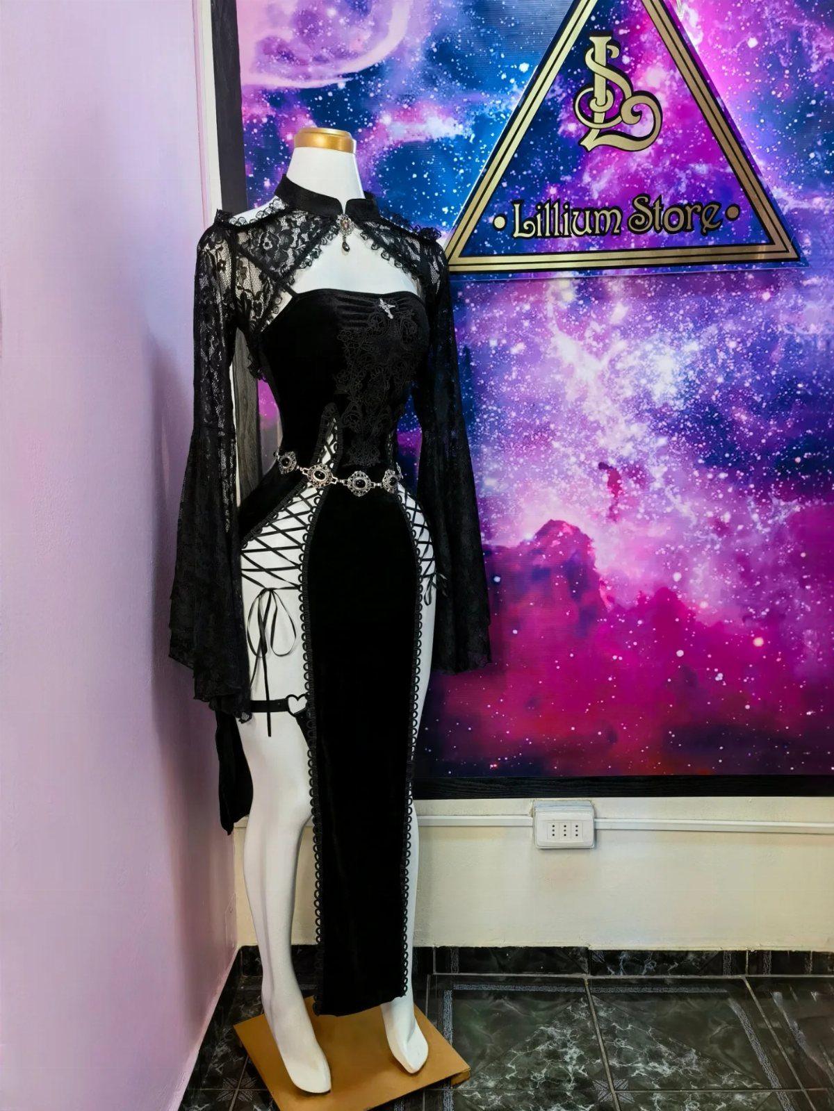 Black gothic lace dress with corset bodice displayed on a white mannequin.