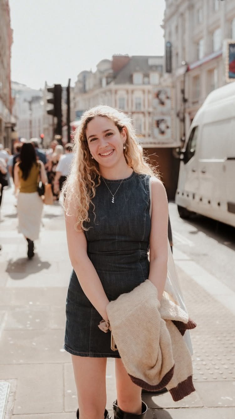 Denim Fitted Dress: 7 Ideas, From Mini to Midi 3 Woman wearing a dark blue sleeveless fitted denim mini dress on a city street