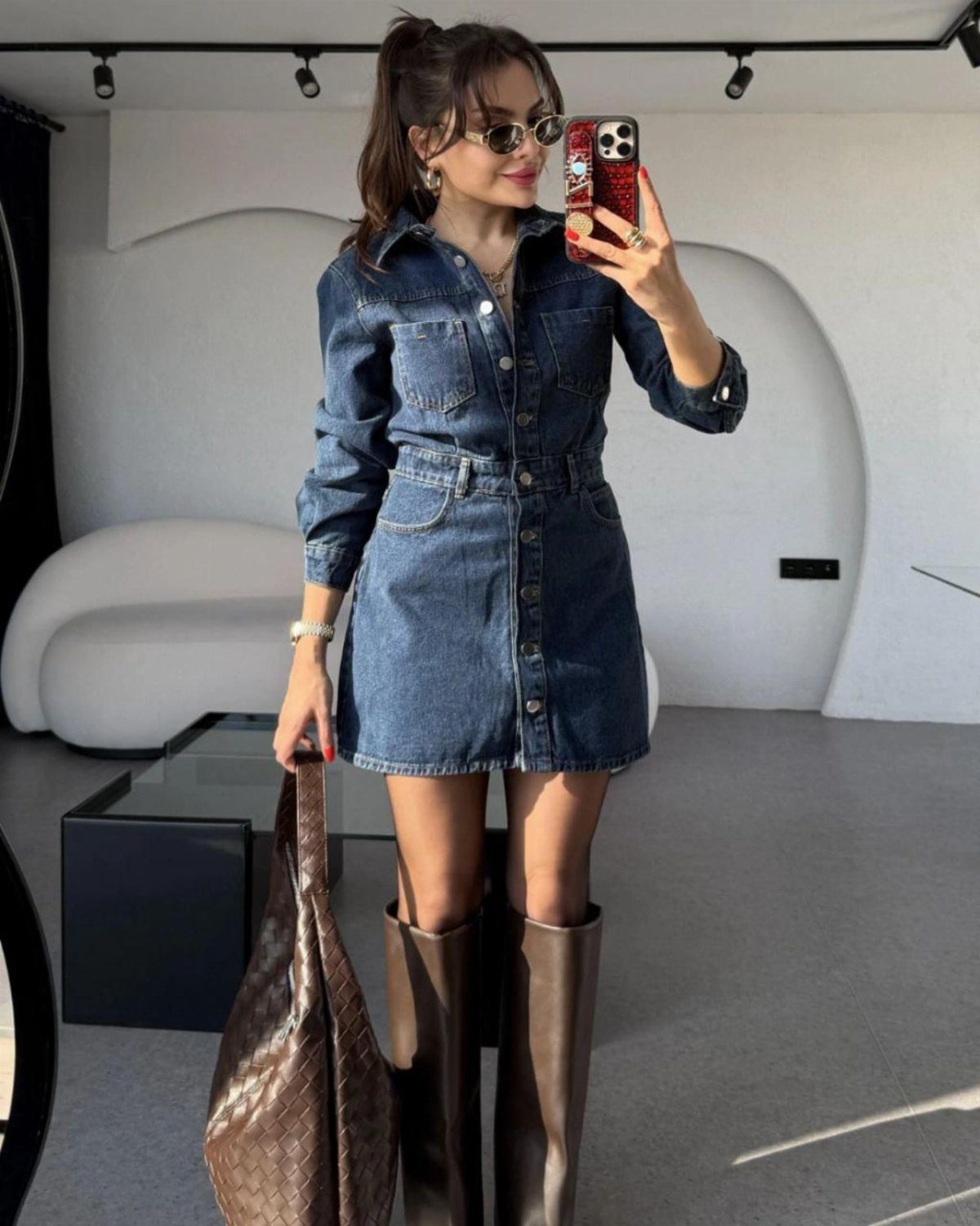 Denim Fitted Dress: 7 Ideas, From Mini to Midi 6 Woman in a dark blue collared denim mini dress and tall brown boots.