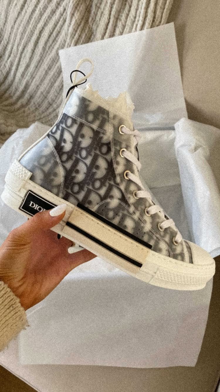 Dior high-top sneaker with black and white monogram pattern and transparent overlay.