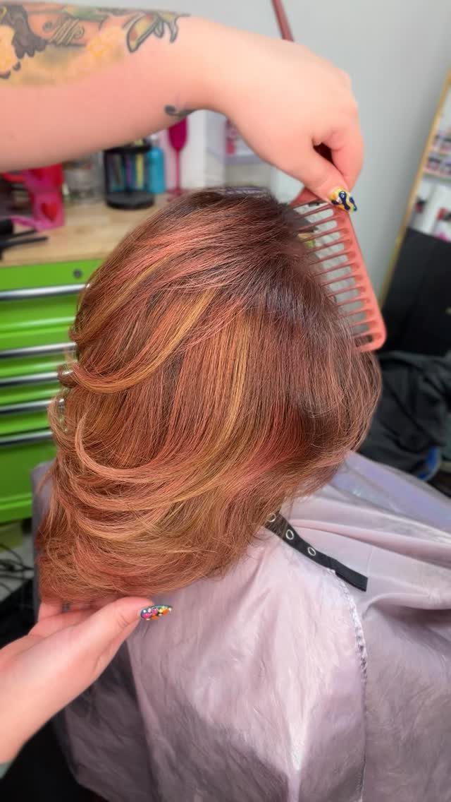 Different Shades of Red Hair Dye: 15 Looks, Copper to Crimson 2 Rose gold and copper wavy hair being styled with a pink comb in salon