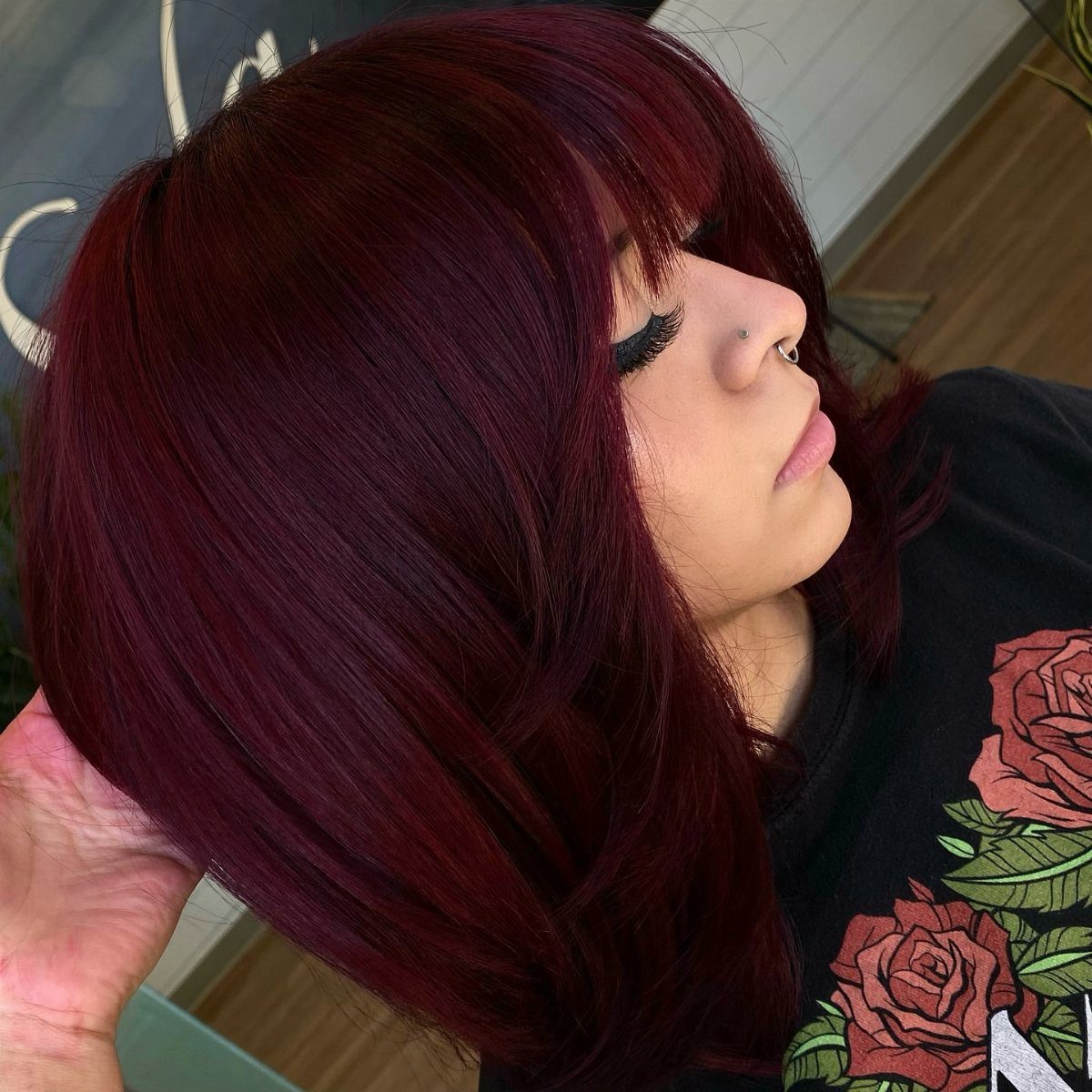 Different Shades of Red Hair Dye: 15 Looks, Copper to Crimson 15 Woman with deep crimson red hair in a bob cut and bangs.