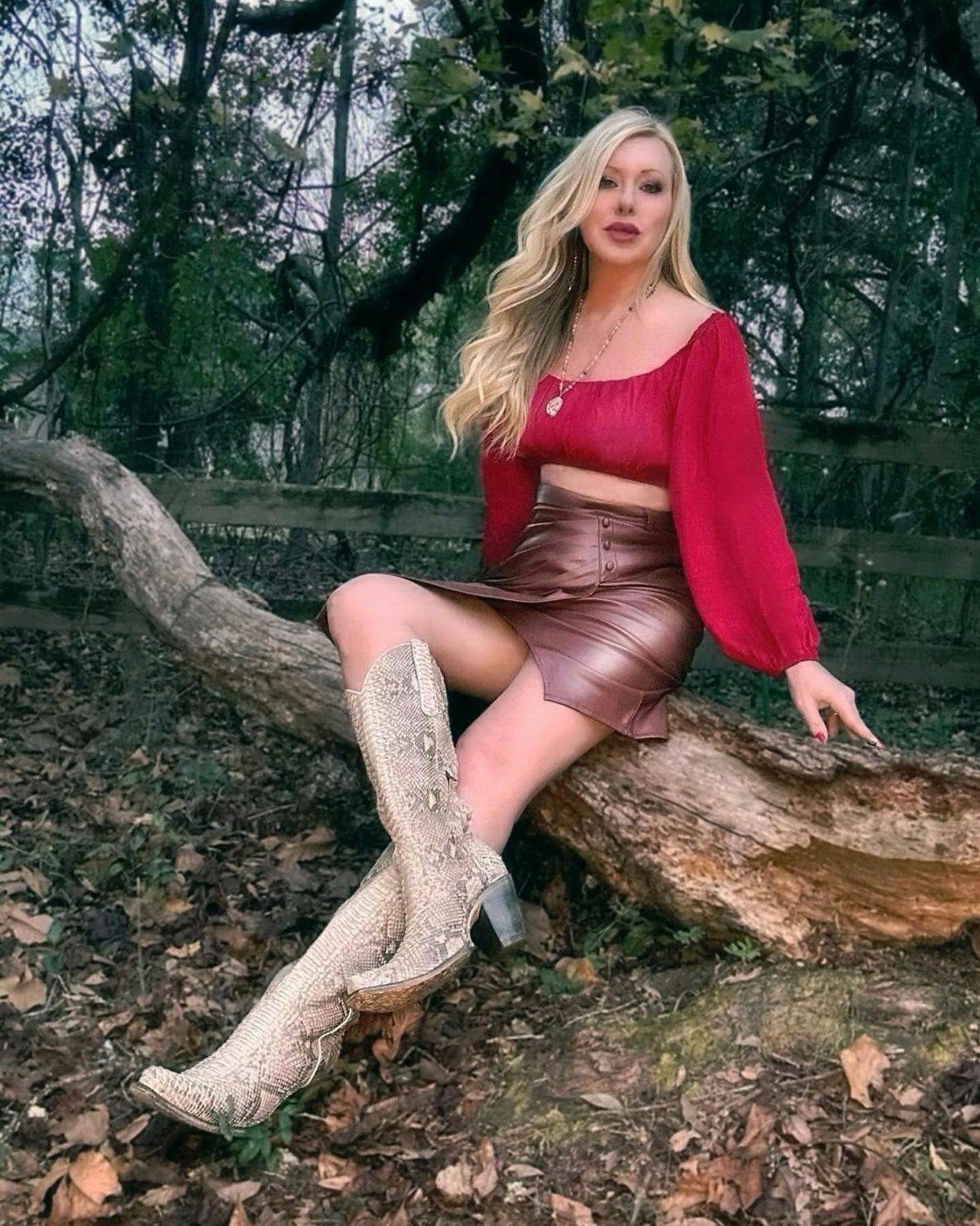 Fall Cowboy Boots for Women: 9 Ideas to Wear Now 8 Woman in red top and leather skirt wearing beige cowboy boots outdoors.