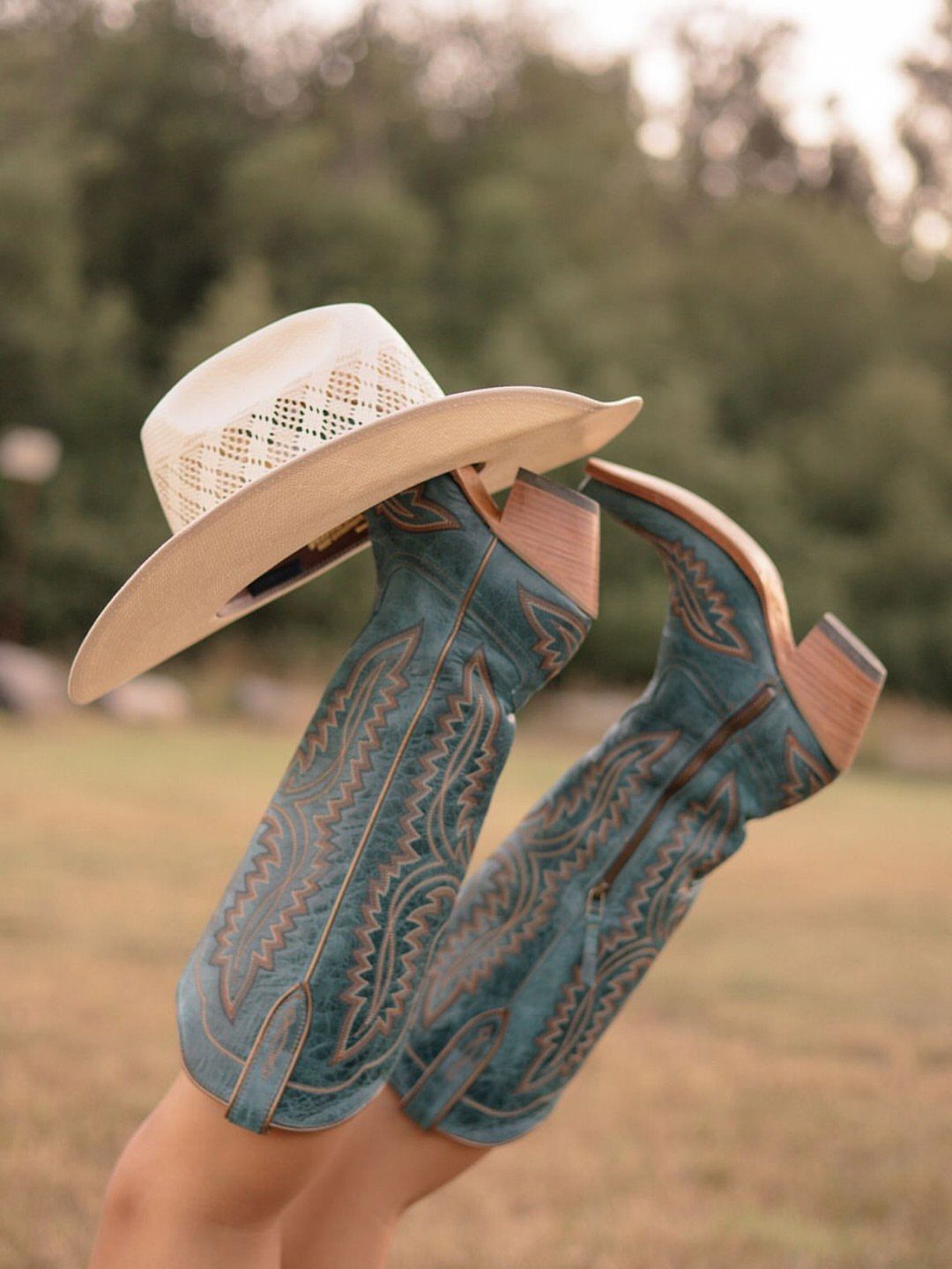 Fall Cowboy Boots for Women: 9 Ideas to Wear Now 6 Turquoise leather cowboy boots with brown stitching and a cream cowboy hat.