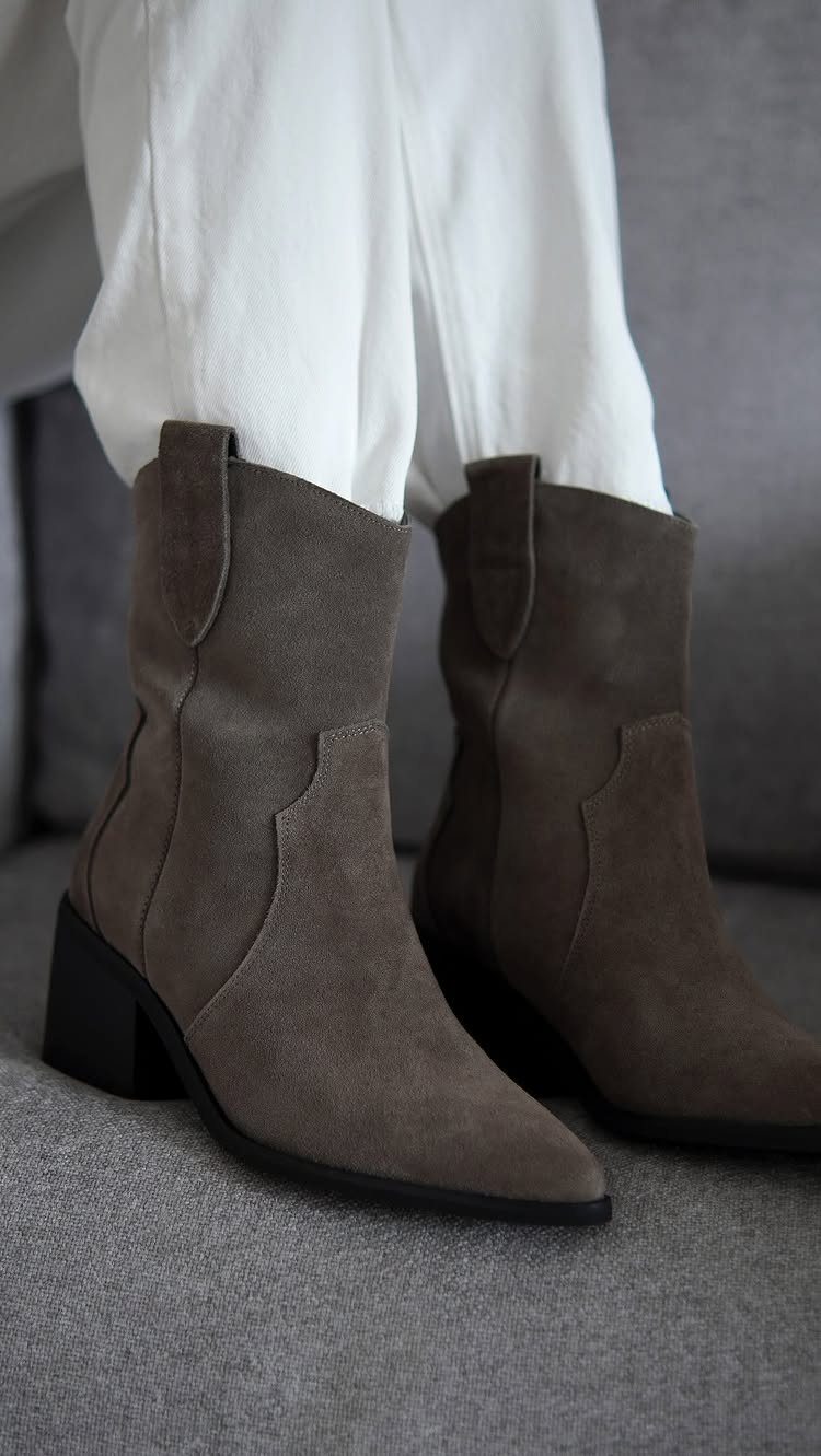 Fall Cowboy Boots for Women: 9 Ideas to Wear Now 1 Grey suede western booties worn with white trousers on a grey background