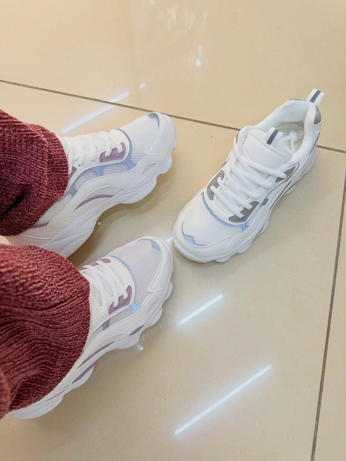 Fancy Sneakers for Women: 9 Ideas, From Retro to Platform 8 White chunky-sole sneakers with silver accents and burgundy knit socks on tiled floor