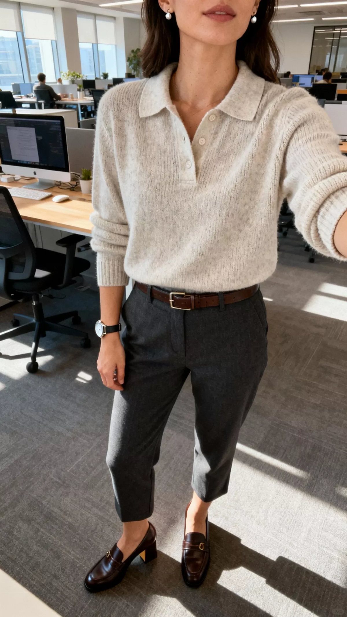 Person wearing a gray knit polo shirt, dark trousers, and brown leather loafers.