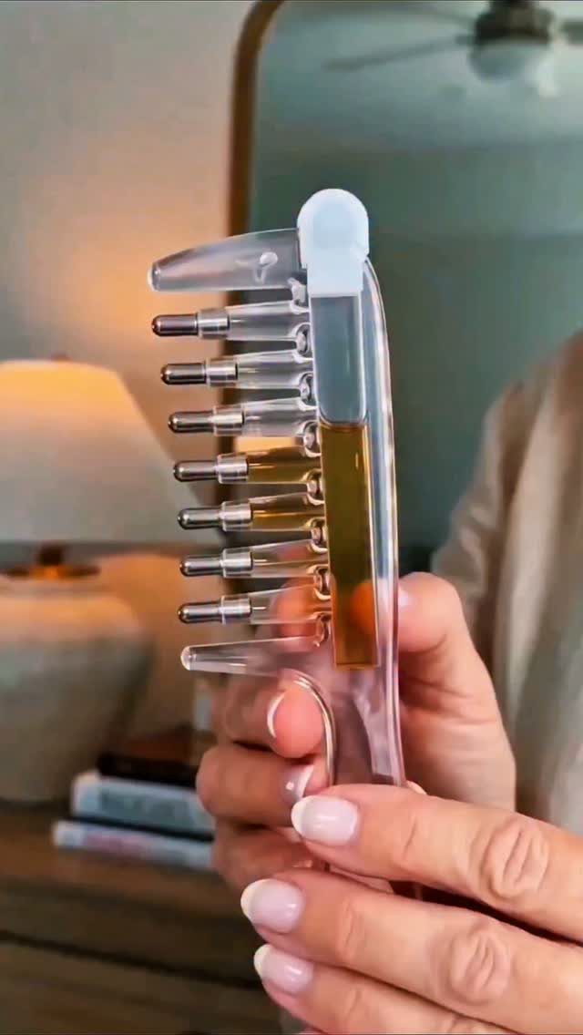 Hair Care at Home: 7 Ideas for Softer, Smoother Hair 7 Clear plastic hair comb with golden oil reservoir held by two hands.