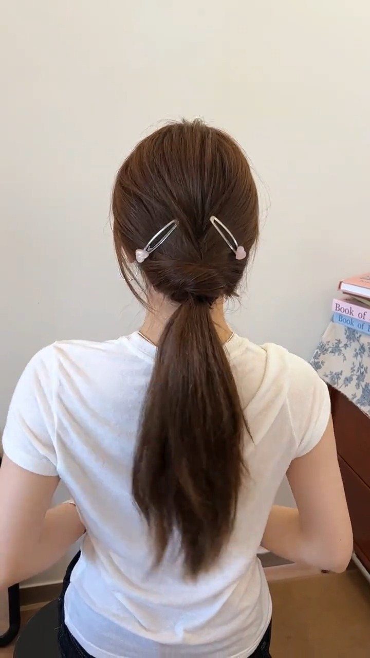 Hair Up Styles to Try: 12 Buns, Ponytails and More 11 Brown hair styled in a low ponytail with pearl hairpins and twisted detail.