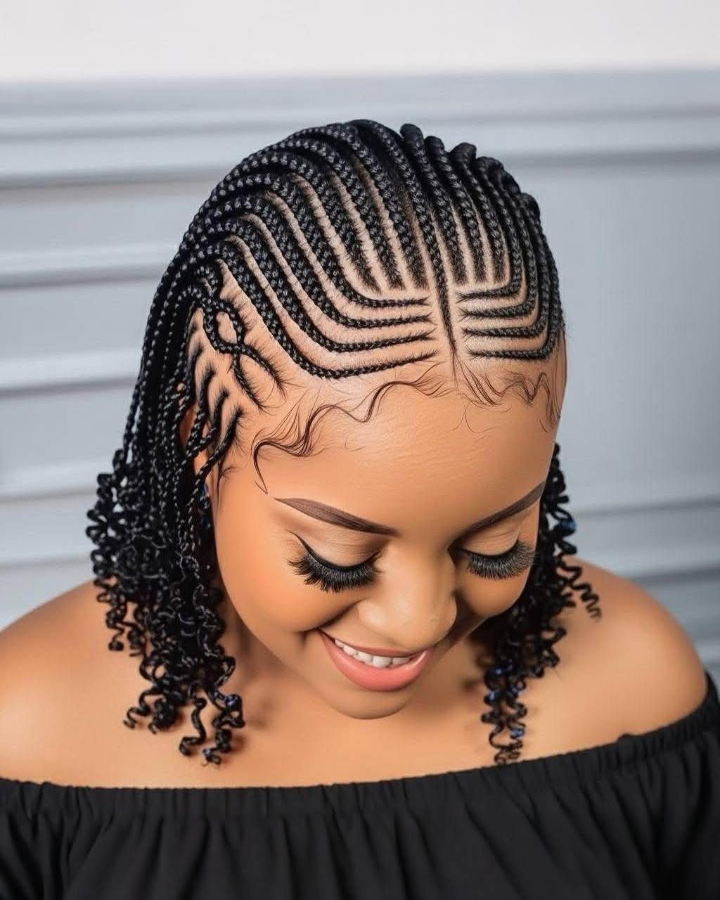 14 Hairstyles for Long Hair for Summer, Easy and Cool 12 Woman with intricate cornrow braids and curly ends wearing a black off-shoulder top.