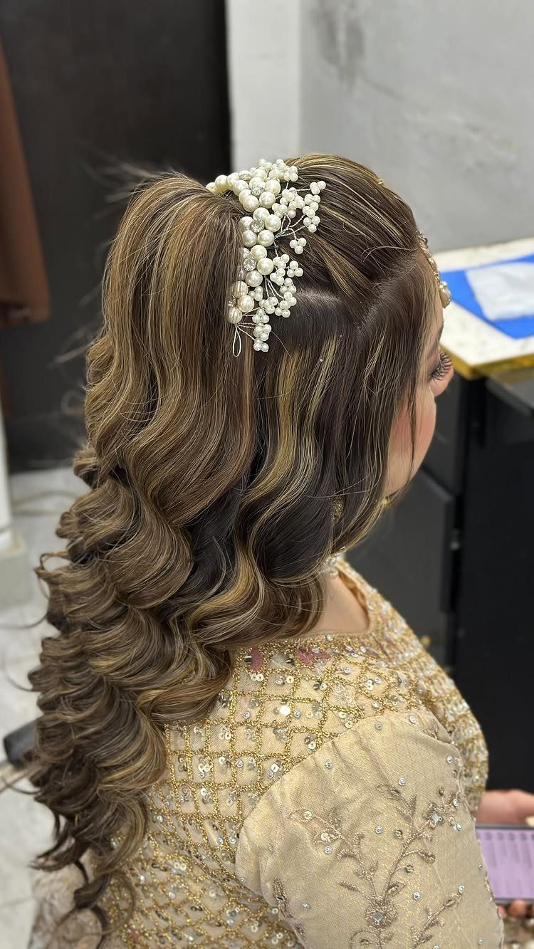 14 Hairstyles for Long Hair for Summer, Easy and Cool 14 Woman with long brown curly hair adorned with a white pearl hair accessory.