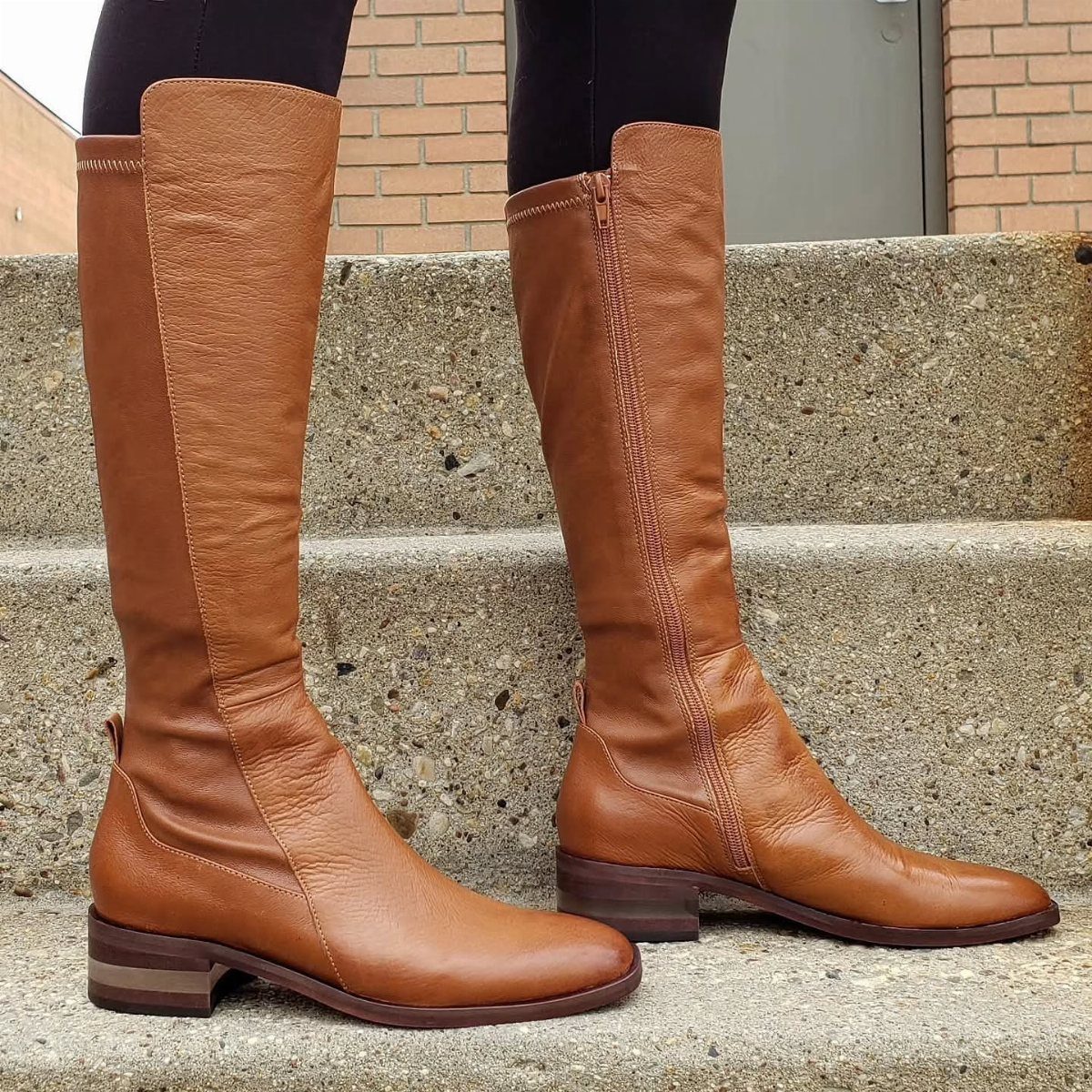 High Cut Boots: 13 Ideas from Kitten Heels to Thigh-High 5 Brown leather knee-high boots with side zippers worn on concrete steps.