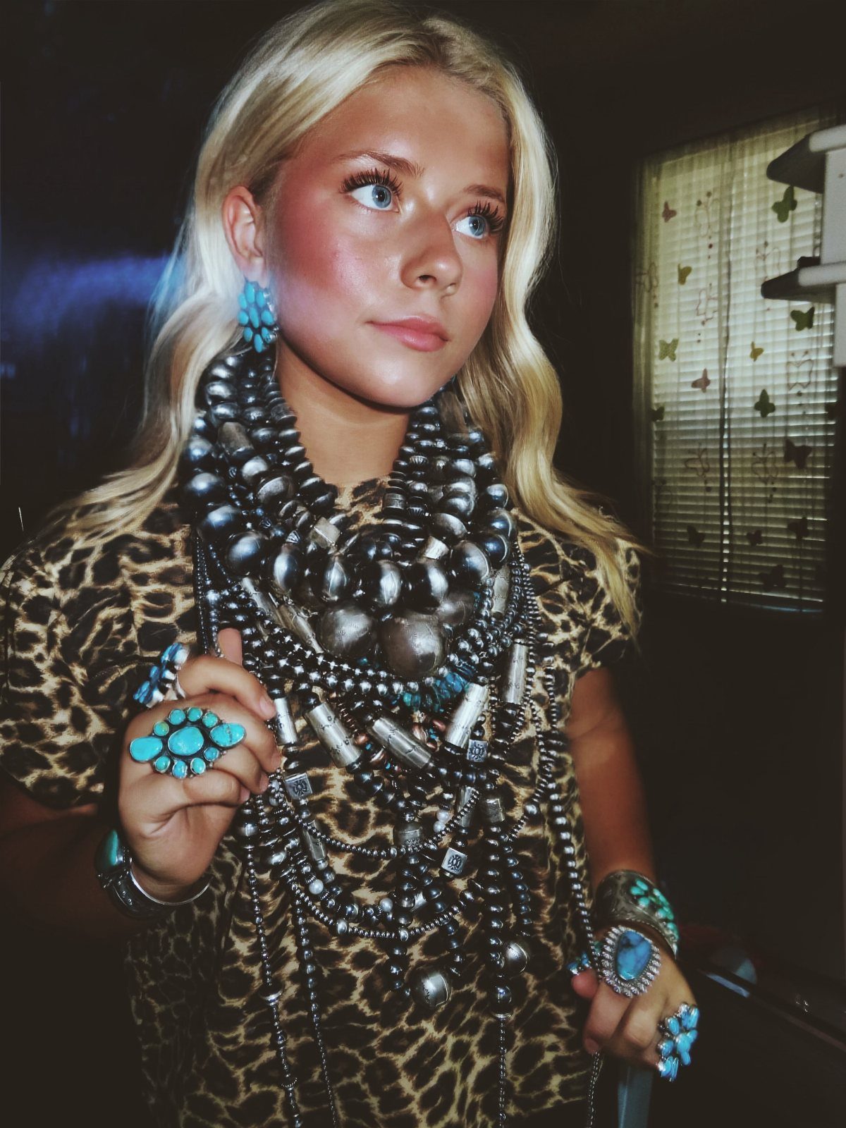 11 Hoedown Outfit Ideas for Boots, Denim and Dresses 11 Woman wearing leopard print shirt with chunky silver and turquoise jewelry set.