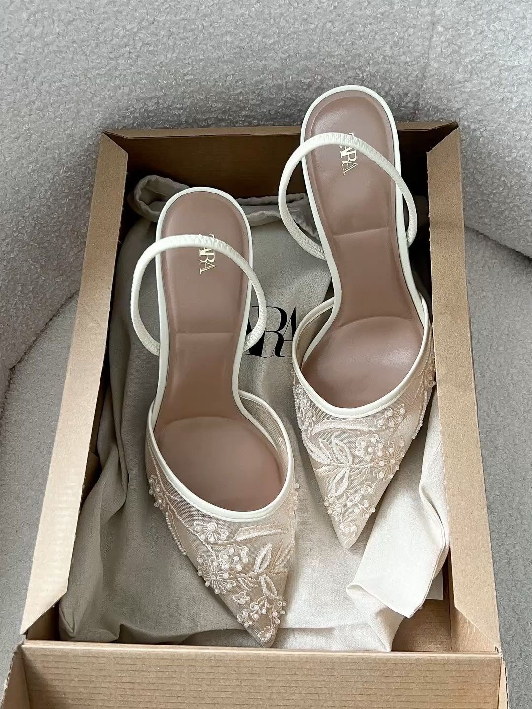 Kitten Heel Shoes for Women: 10 Ideas and Outfits 8 Pointed-toe slingback kitten heels with white floral embroidery inside a brown shoebox.