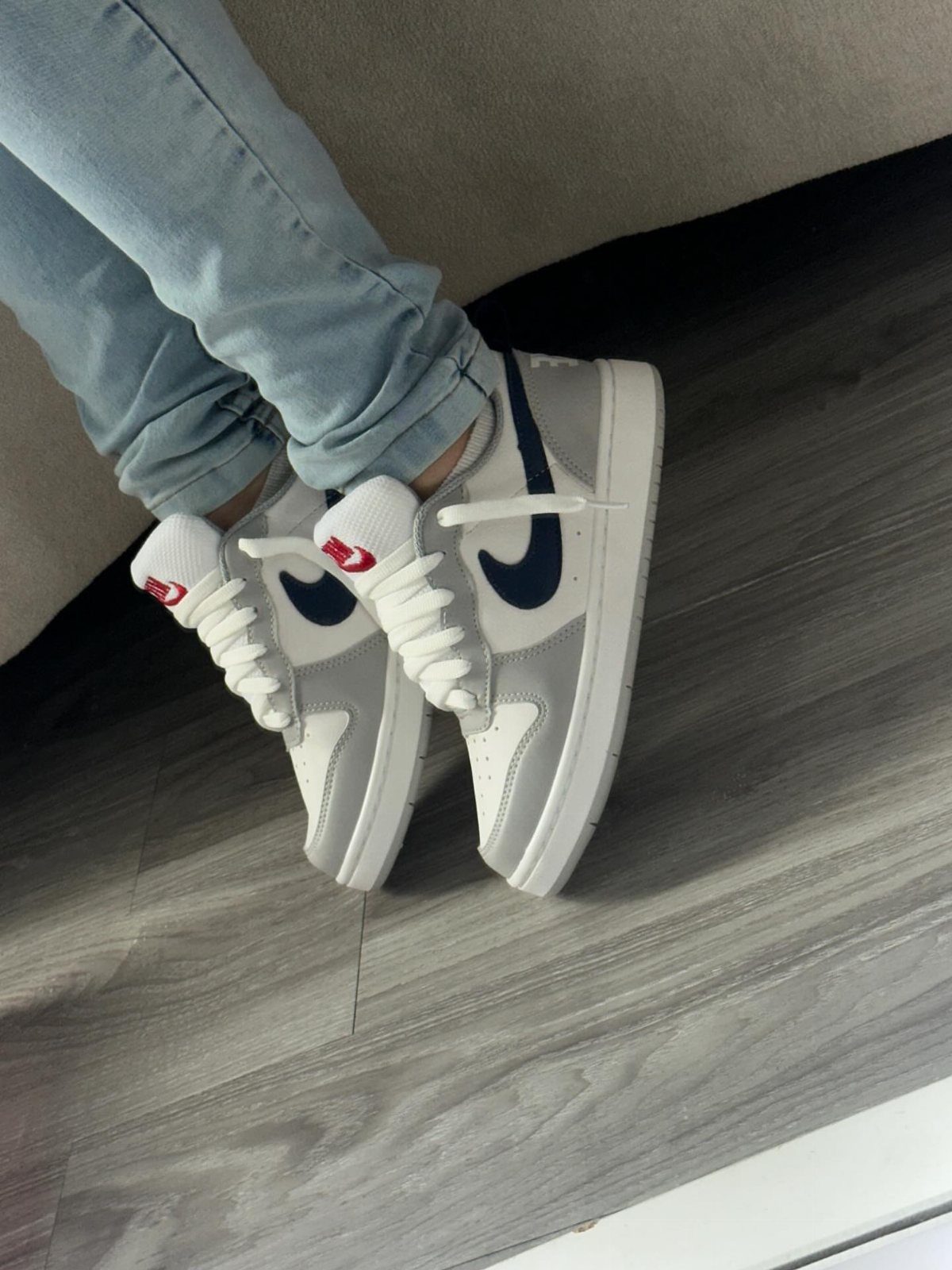 Light Grey Dunks: 5 Ideas, From Smoke Grey to Gum Soles 2 Light grey Nike Dunk sneakers paired with light blue denim jeans on wooden flooring
