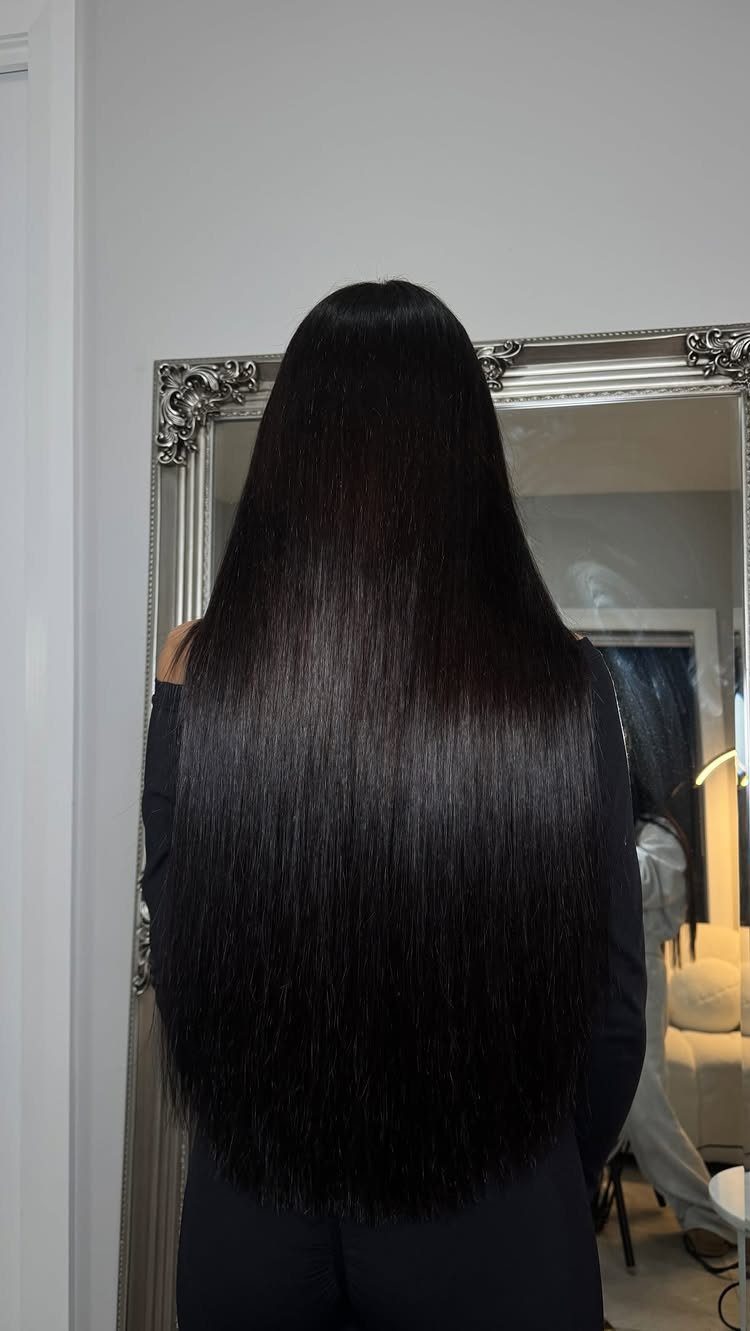 Long Russian Hair Ideas: 8 Looks, Colors and Textures 8 Long straight glossy black hair seen from behind in front of a mirror