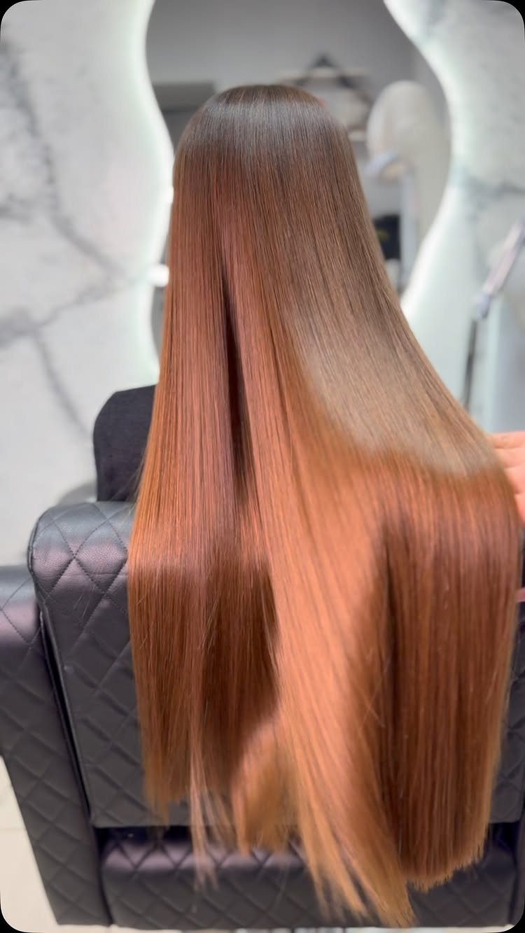 Long Russian Hair Ideas: 8 Looks, Colors and Textures 7 Long, straight, glossy brown hair flowing down a person's back in a salon.