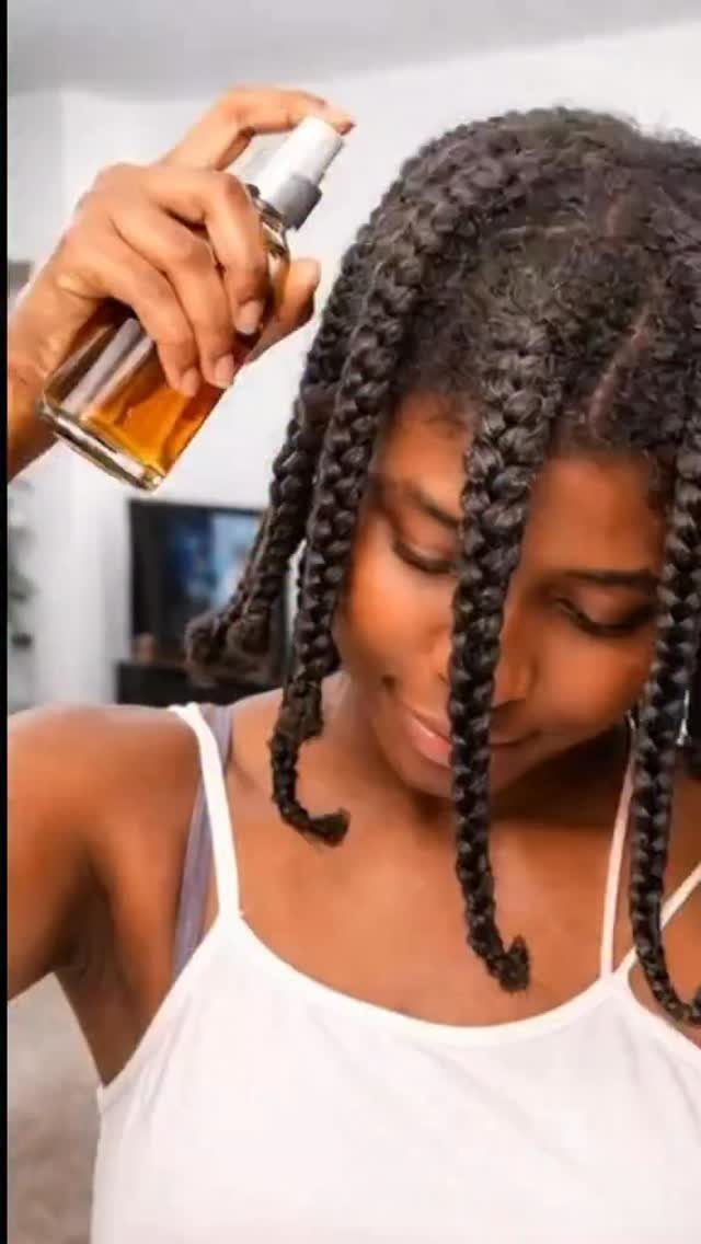 7 Ways to Make Hair Grow Faster, From Biotin to Microneedling 6 Woman with braided hair applying a hair growth spray to her scalp.