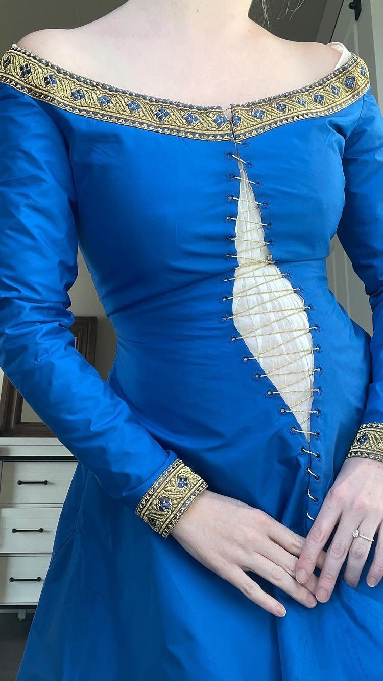 Blue medieval gown with gold embroidery and laced front over white undergarment