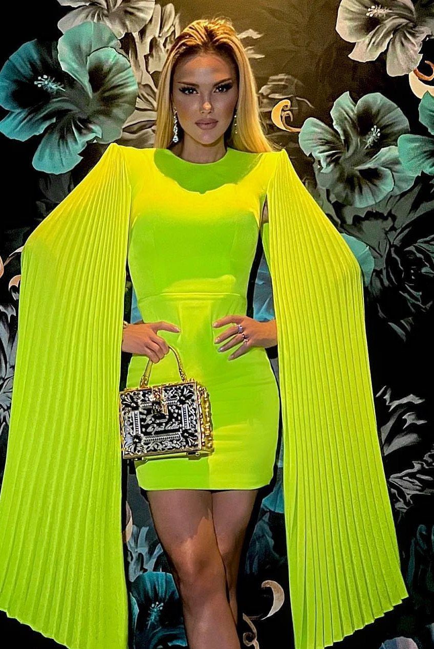 Miami Club Outfits: 8 Ideas for Day and Night 2 Woman in a neon yellow mini dress with pleated sleeves and sparkly handbag.