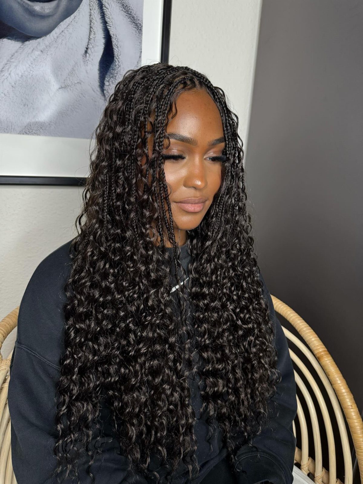 Natural Long Hairstyles: 10 Ideas, From Bantu Knots to Waves 10 Woman with long, dark, curly mermaid braids cascading over her shoulders and chest.