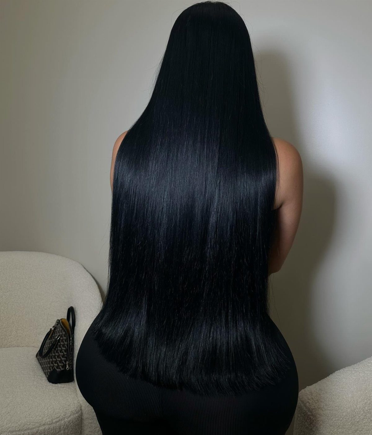 Natural Long Hairstyles: 10 Ideas, From Bantu Knots to Waves 7 Long, sleek pin straight black hair flowing down a woman's back.