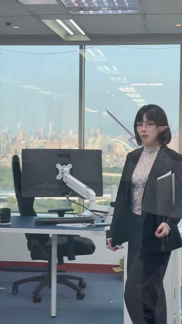 Woman in black blazer and lace top standing in a modern city office.