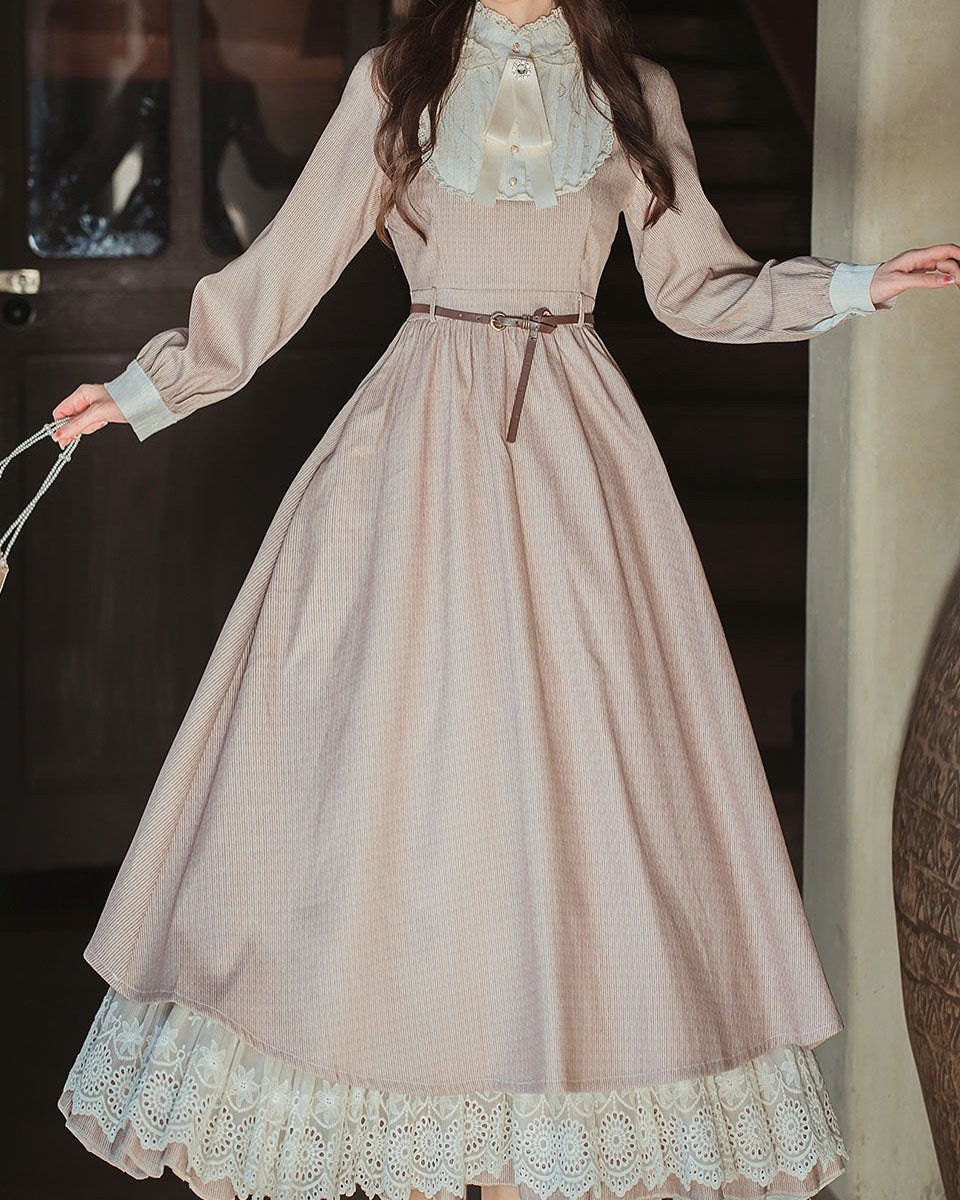 Vintage-style striped dress with lace collar and hem worn by a person.