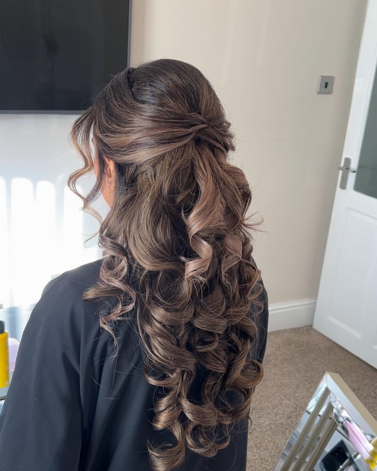 11 Peinado Pelo Rizado Ideas for Every Curl Type 4 Brown curly hair styled in a half-updo with long defined ringlets falling down.