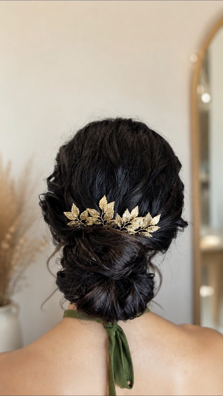 11 Peinado Pelo Rizado Ideas for Every Curl Type 3 Dark curly hair styled in a low bun with a gold leaf accessory.