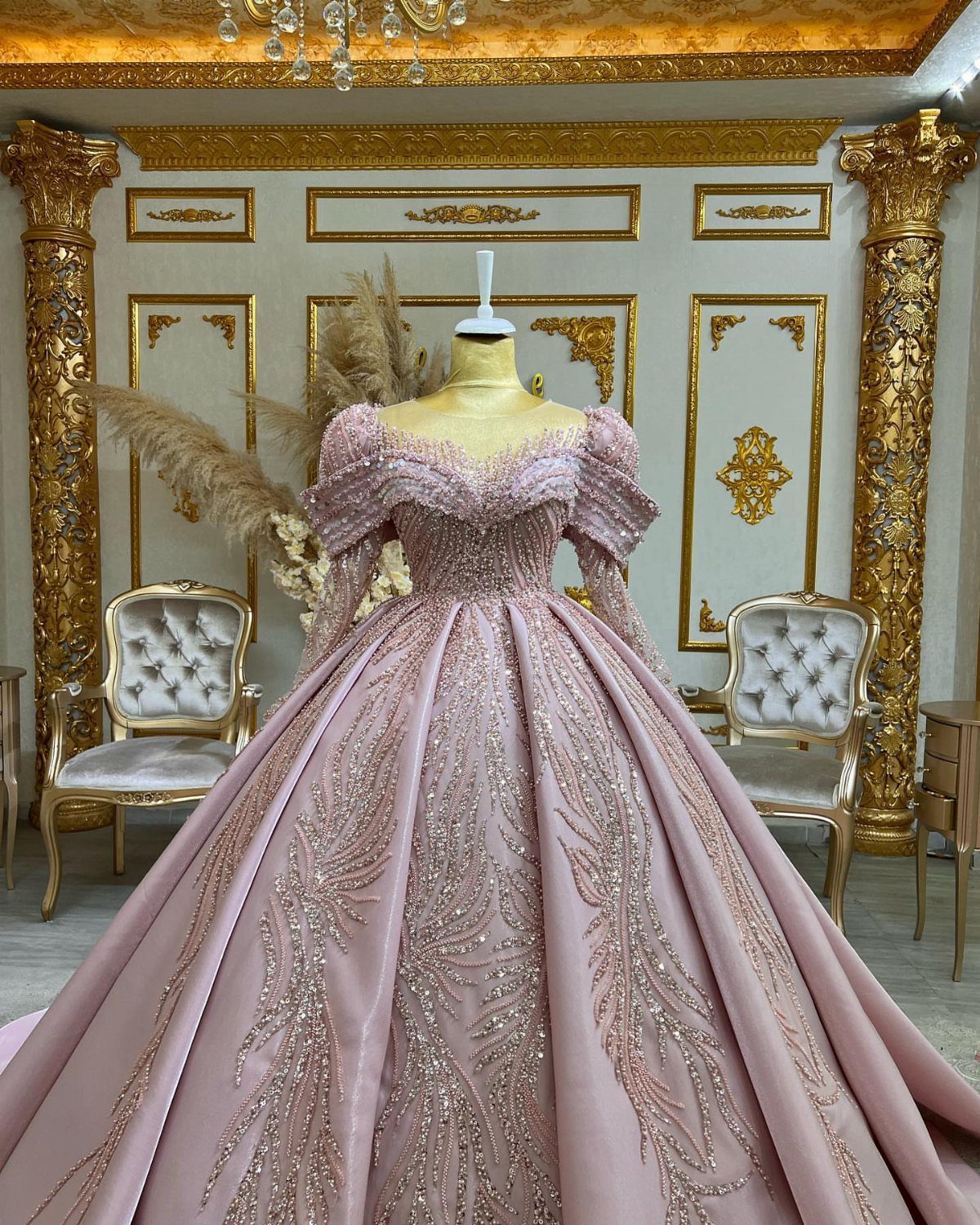 Pink Ballgown Wedding Dress: 8 Ideas with Bows and Feathers 1 Dramatic pink ballgown with voluminous skirt and shimmering embroidery on a mannequin