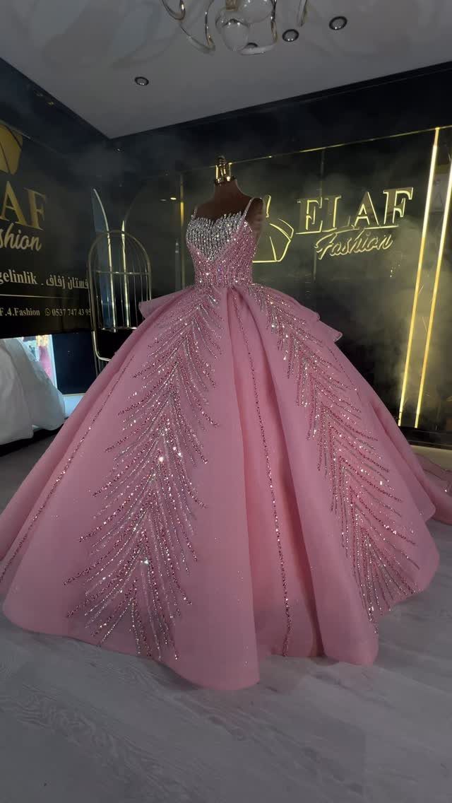 Pink Ballgown Wedding Dress: 8 Ideas with Bows and Feathers 7 Pink ballgown wedding dress with silver beaded bodice and leaf embroidery on a mannequin