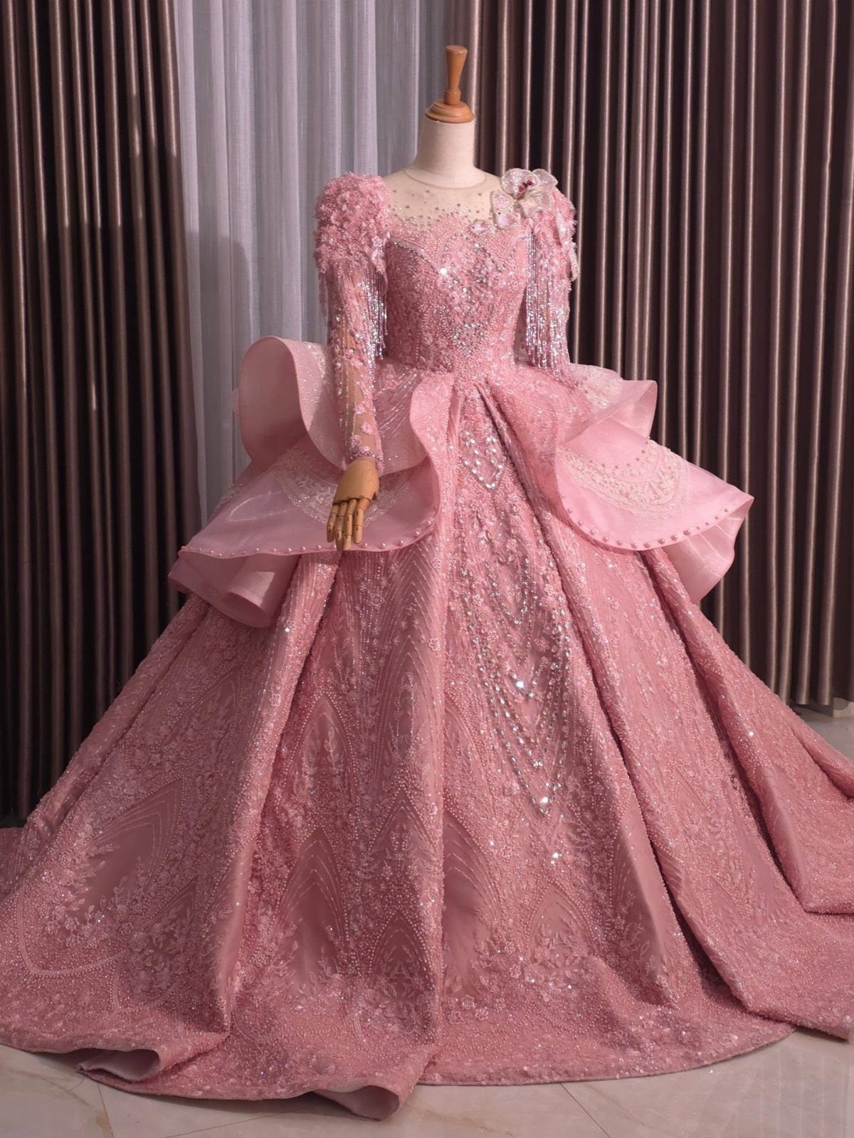 Pink Ballgown Wedding Dress: 8 Ideas with Bows and Feathers 4 Sparkling pink ballgown wedding dress with long sleeves on a mannequin.