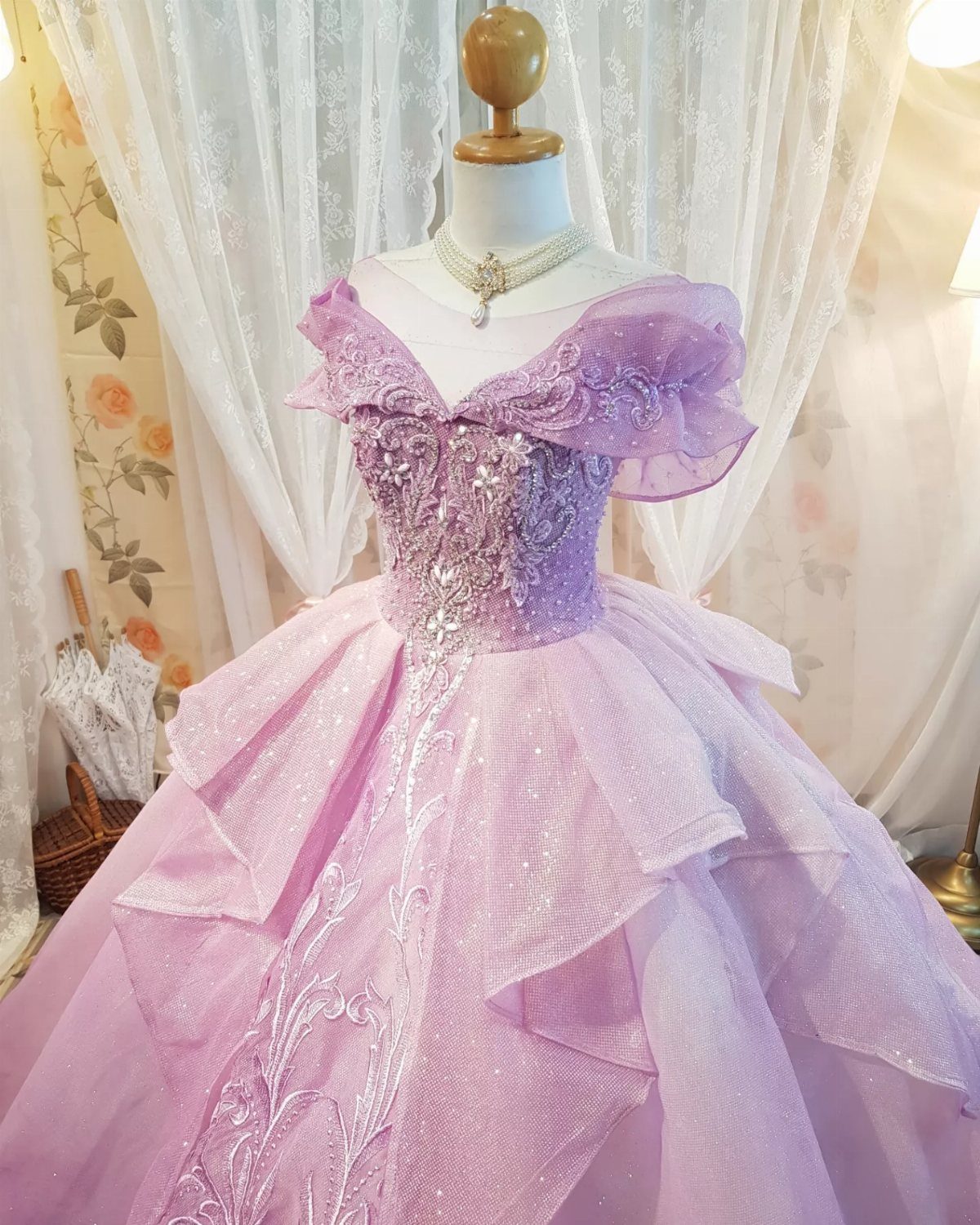 Pink Ballgown Wedding Dress: 8 Ideas with Bows and Feathers 5 Pink sparkling ballgown wedding dress with tiered skirt on a white mannequin