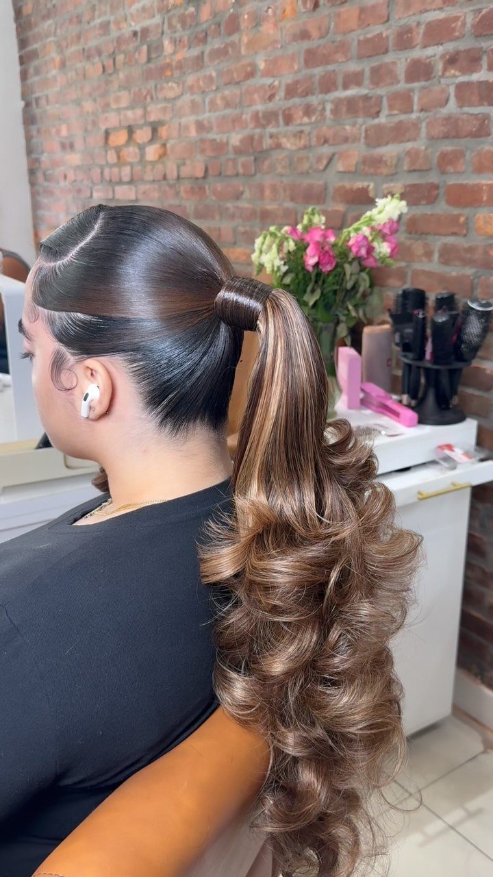 8 Prom Ponytail Hairstyles from Sleek to Curly 4 Woman with a high Barbie ponytail featuring curled ends and a hair wrap.