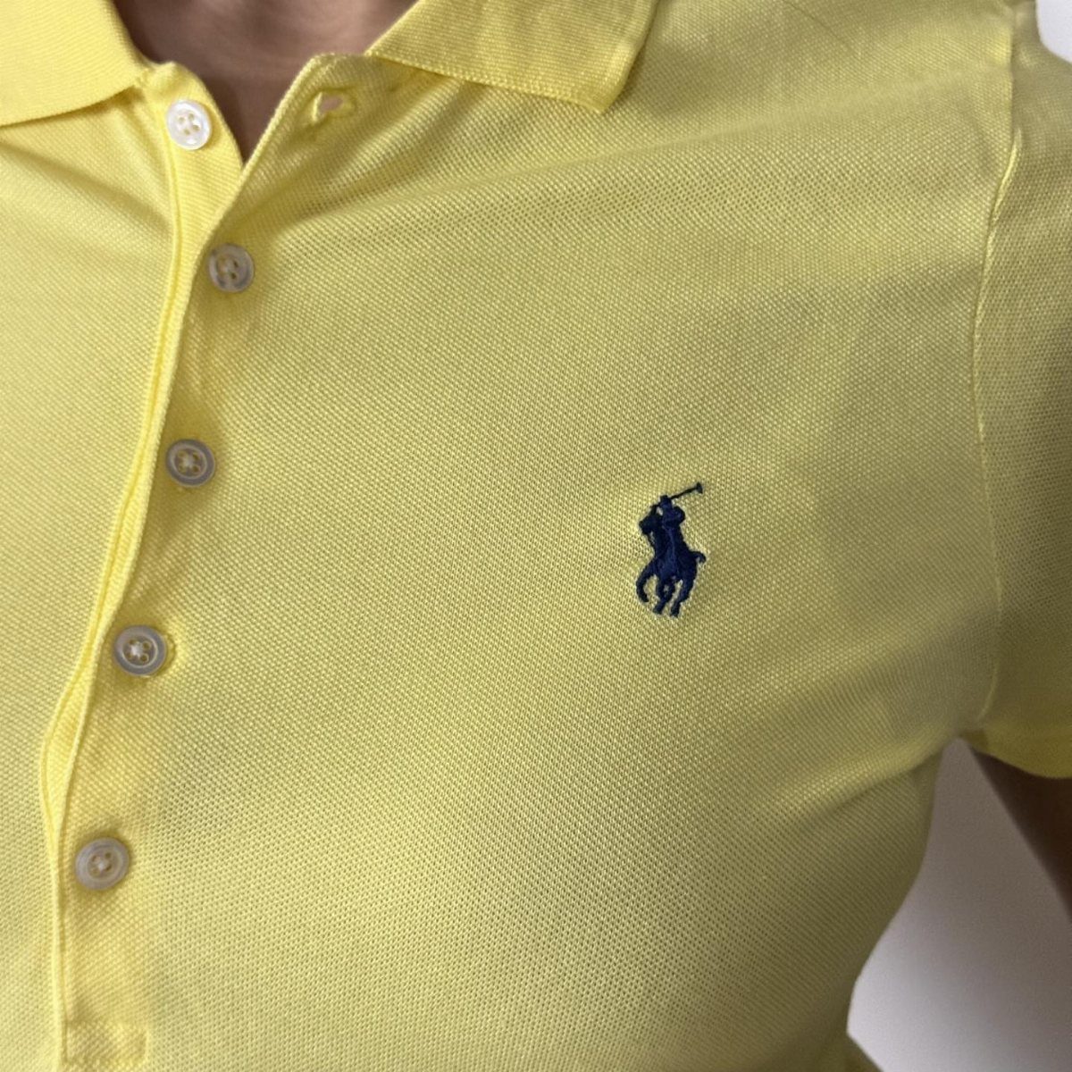 Ralph Lauren Yellow Polo Outfits: 6 Ways to Wear One 6 Yellow Ralph Lauren polo shirt with navy blue embroidered logo on the chest.