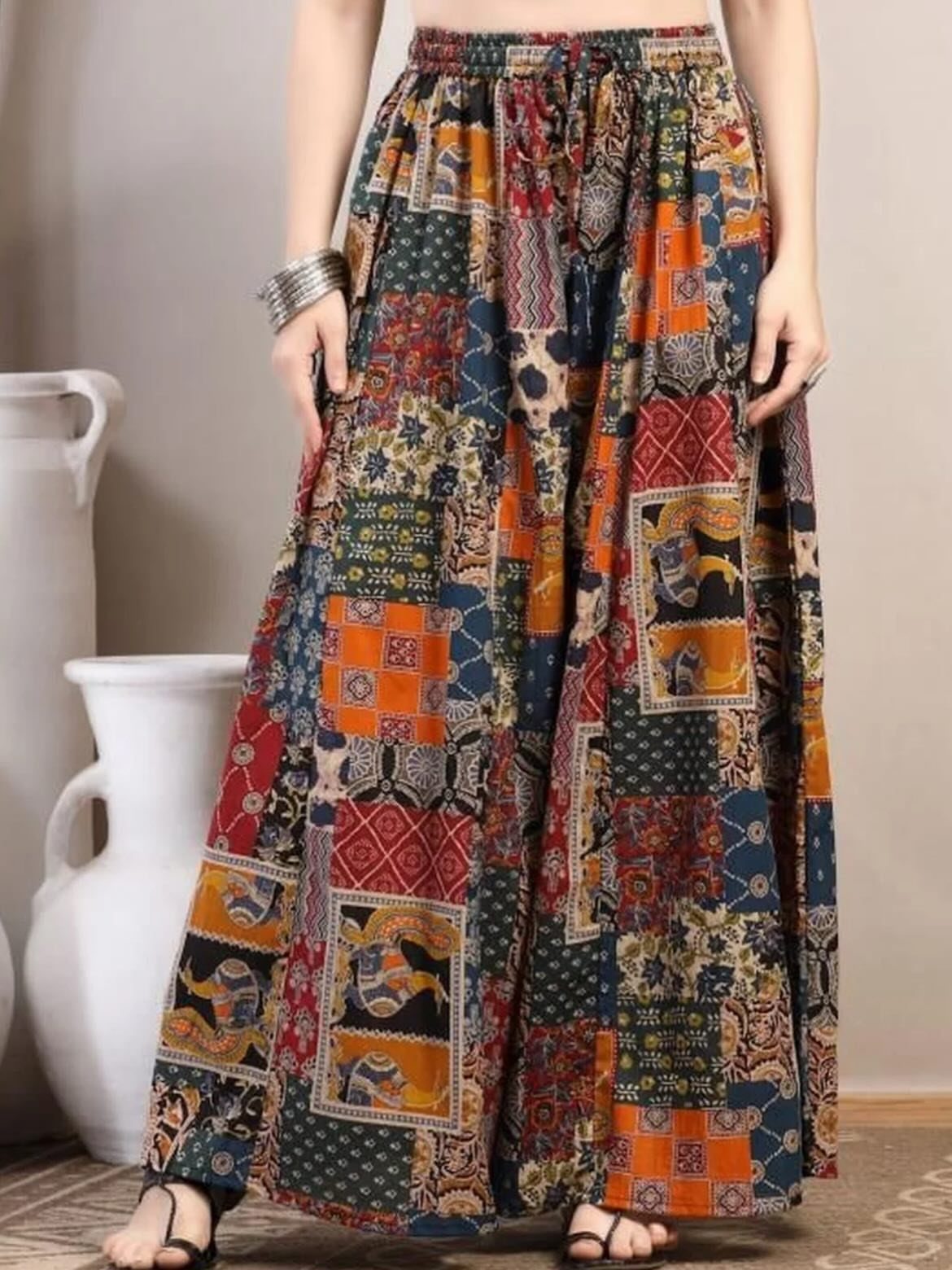 6 Retro Bell Bottoms Ideas for Every Closet and Mood 6 Wide leg palazzo pants with colorful patchwork patterns worn by a person.