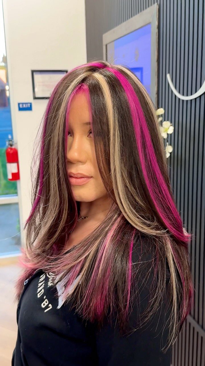 20 Summer Hair Dye Ideas, from Pastel Blue to Cool Raven 12 Woman with long brown hair featuring bold blonde and magenta pink chunky highlights.