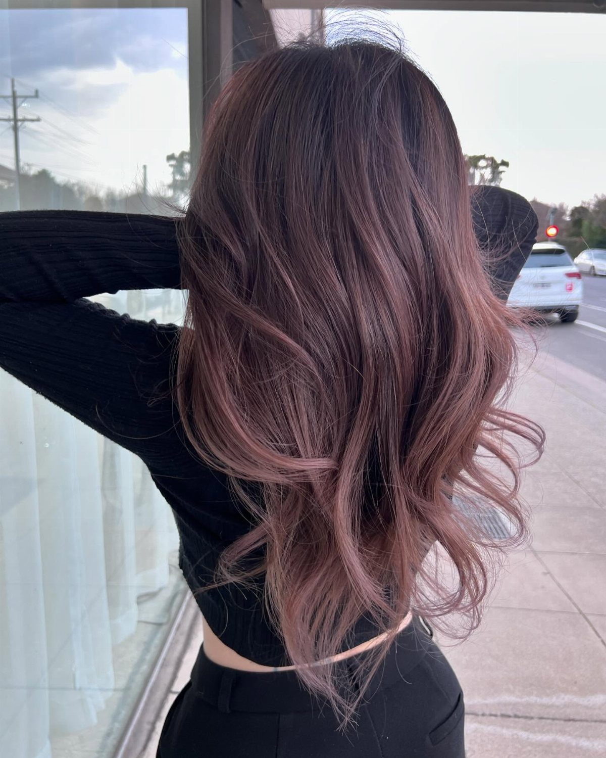 20 Summer Hair Dye Ideas, from Pastel Blue to Cool Raven 16 Long wavy mauve brown hair seen from behind on a person outdoors.