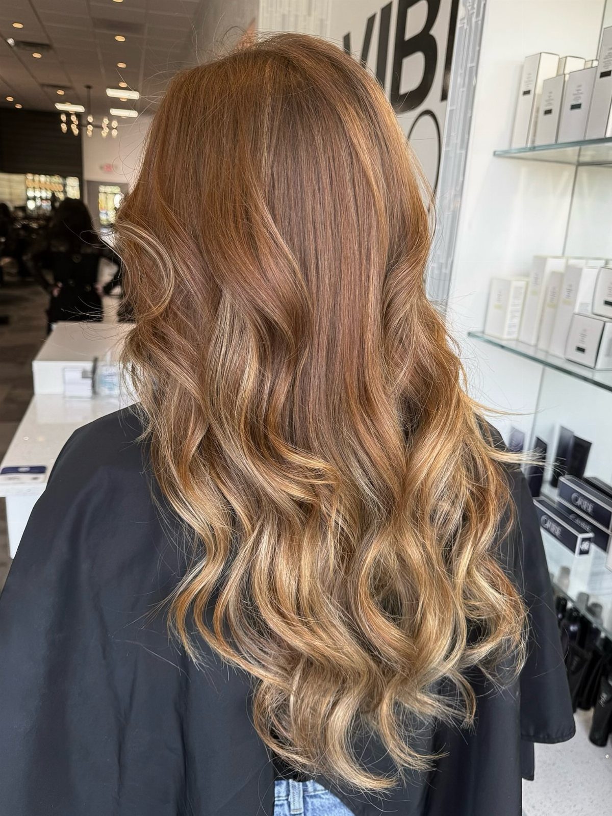 20 Summer Hair Dye Ideas, from Pastel Blue to Cool Raven 15 Long wavy hair with a reddish-brown to golden-blonde balayage in a salon.