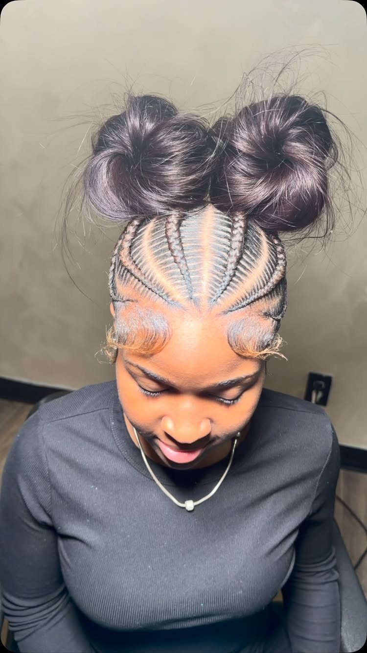 Two Braids with Bun Hairstyles: 4 Ideas to Try 2 Woman with cornrows leading into two large buns on top of her head