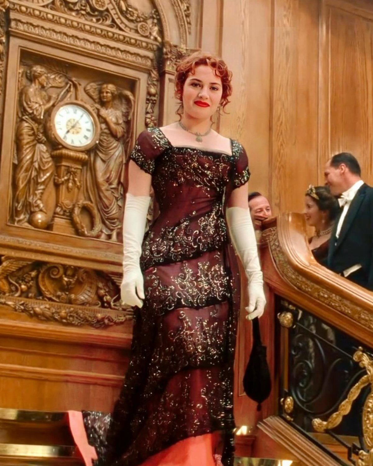 Vintage Hollywood Gown Ideas: 5 Looks in Red and Burgundy 2 Woman in a sparkling burgundy vintage gown and white gloves in ornate interior