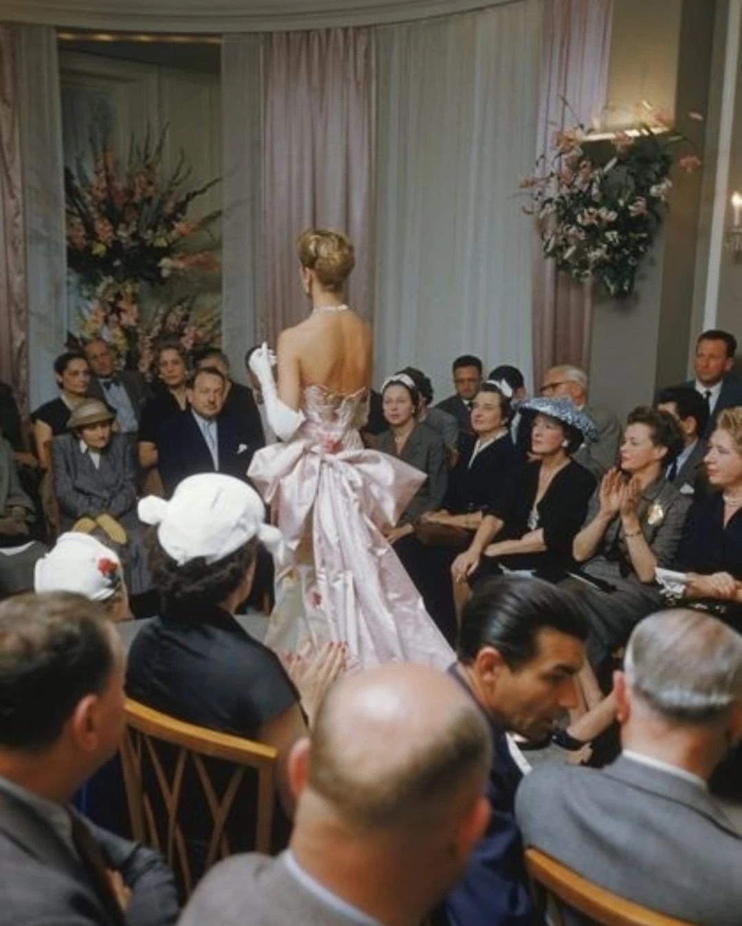 Vintage Hollywood Gown Ideas: 5 Looks in Red and Burgundy 3 Woman in a pale pink vintage strapless gown with a large bow and gloves.