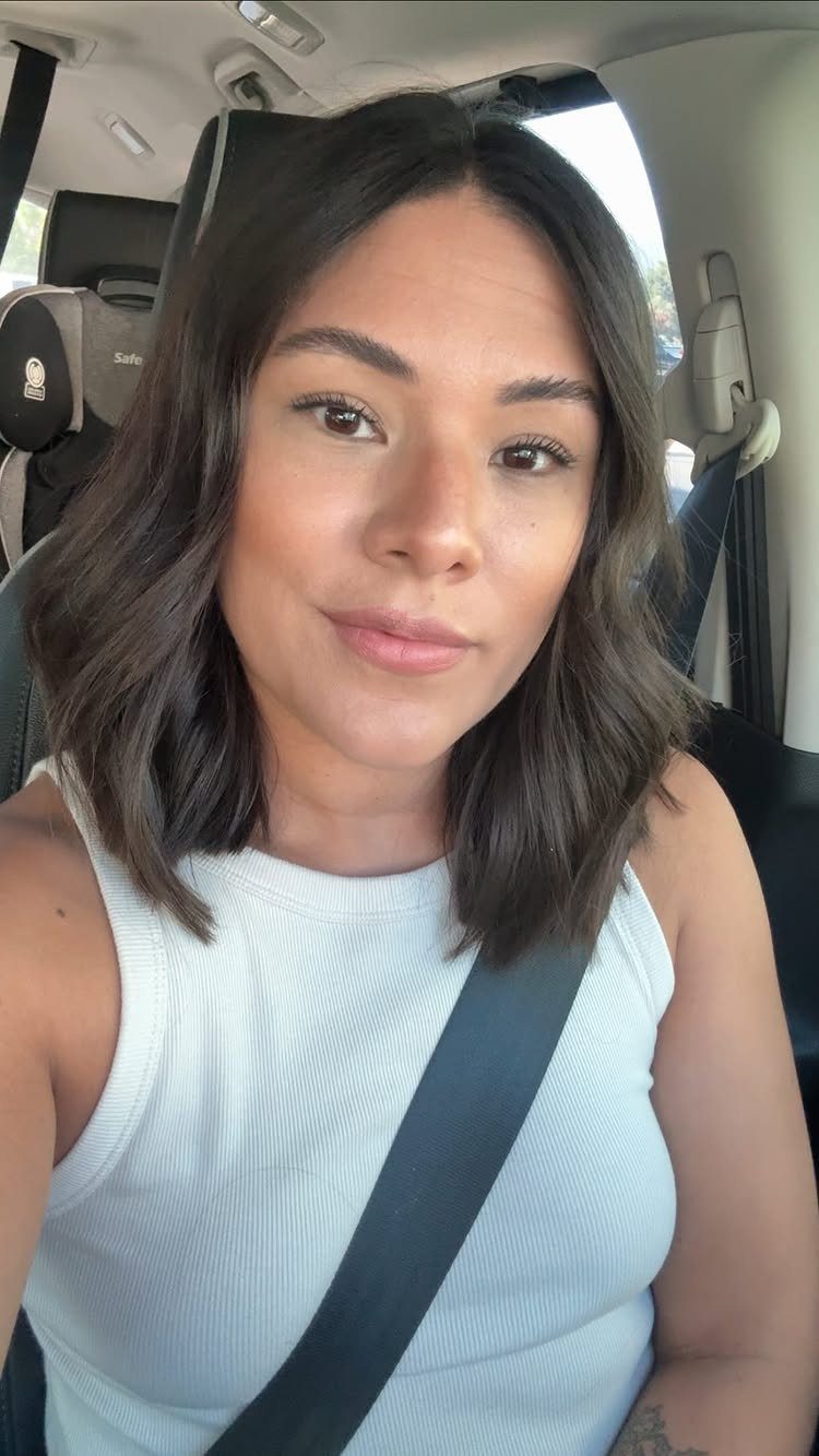 Wavy Hair Styles for Women: 12 Cuts and Looks to Try 1 Woman with a center-parted wavy lob hairstyle sitting in a car