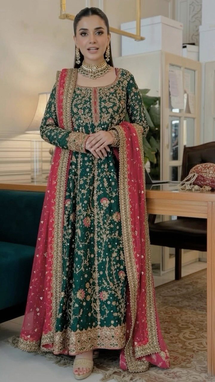 10 Wedding After Party Outfit Ideas for Guests 8 Woman in a green embroidered gown and red dupatta for a wedding guest outfit