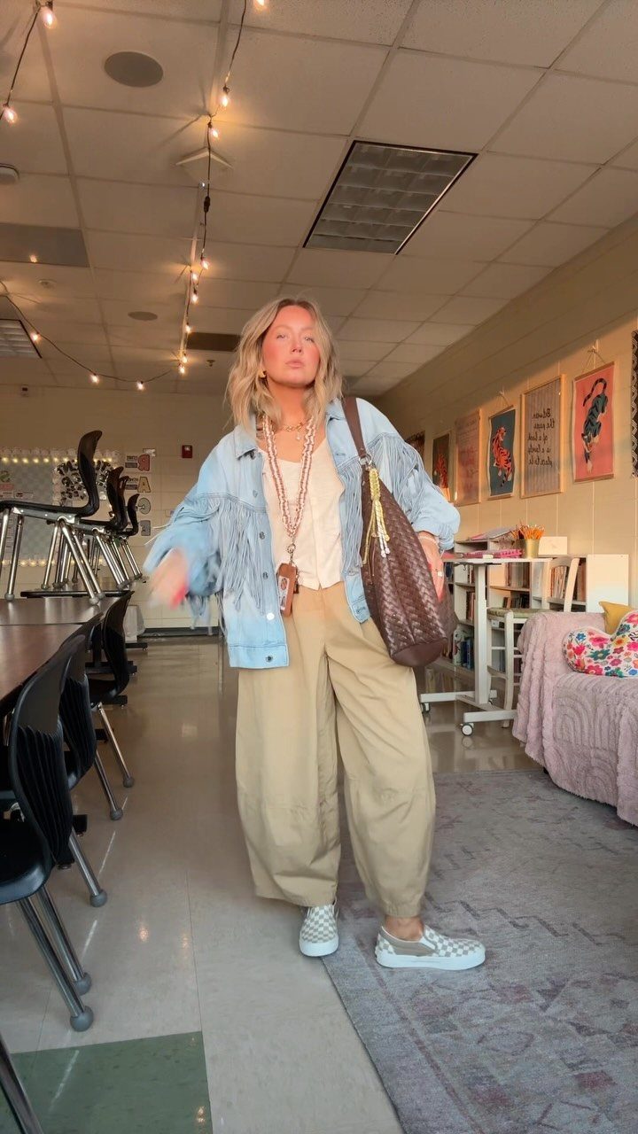 Western Dress Up: 5 Ideas, From Dresses to Denim Jackets 5 Woman wearing a light-wash denim jacket and tan wide-leg trousers in a classroom